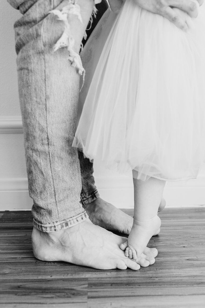 one year photos Boise, baby feet standing between parents