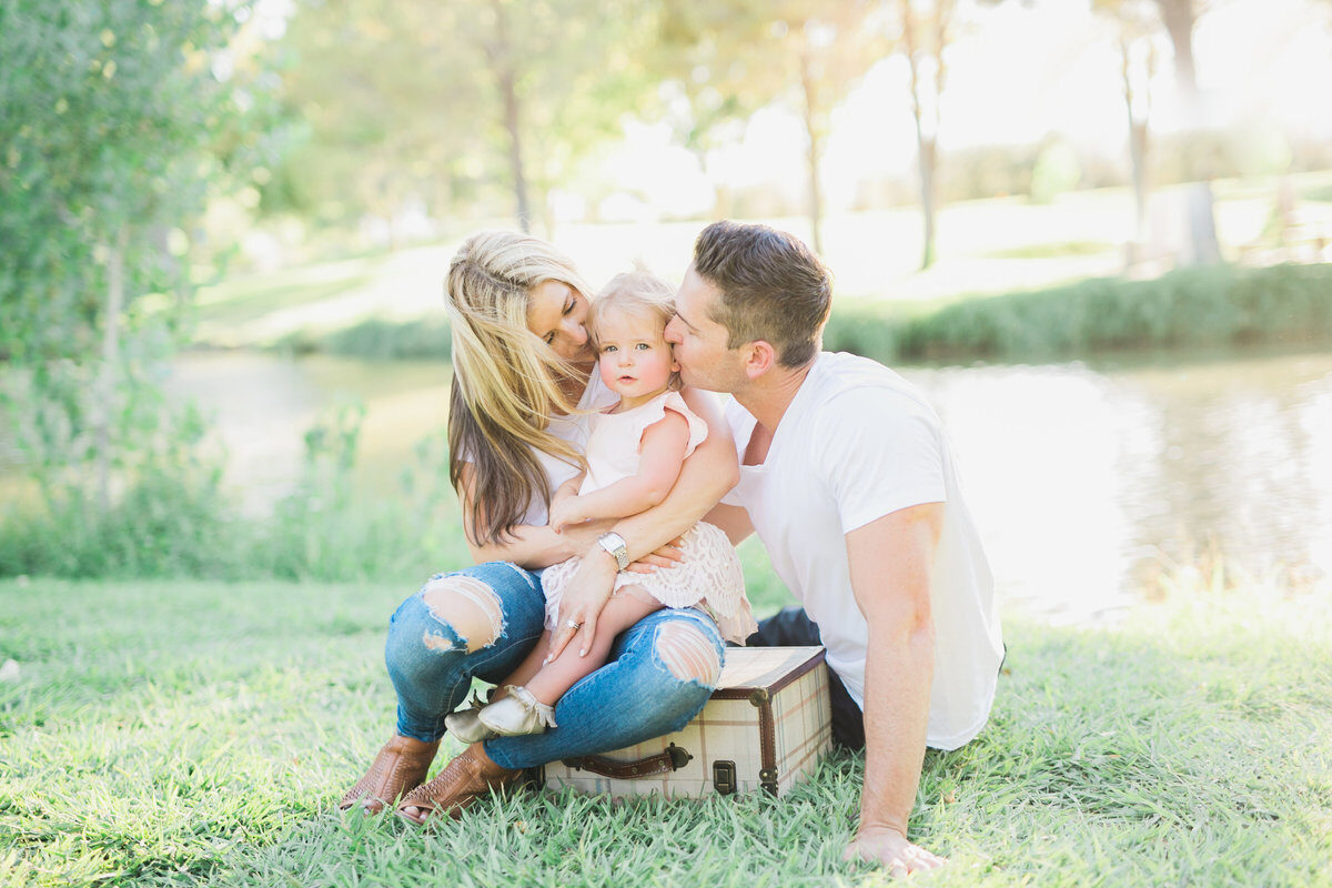 Family cuddled together at lakeside picnic, Boise family photographer on location