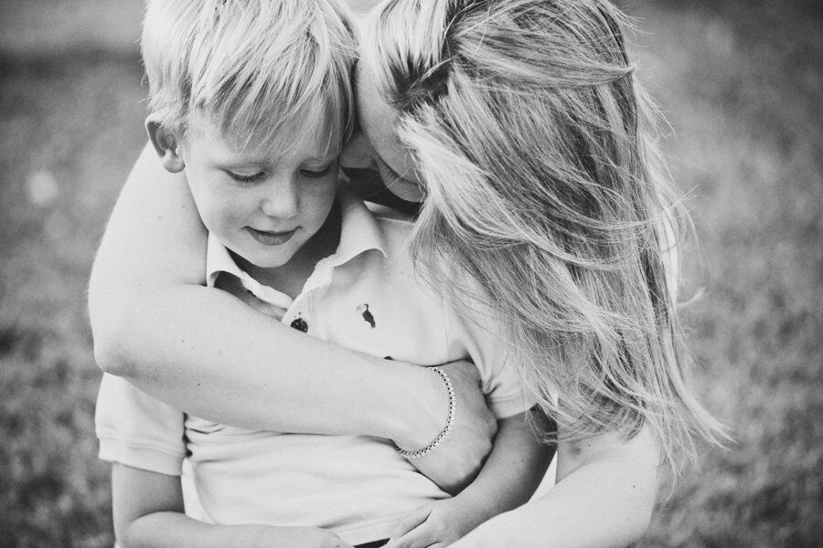 Black and white photo of mother hugging her son close, Boise family photography