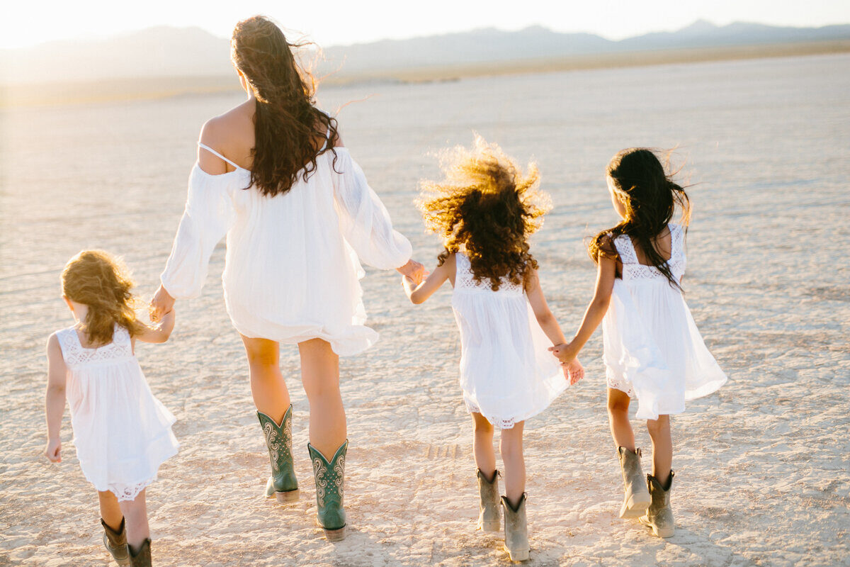Mother and son walking together in desert landscape, Boise family photos on location