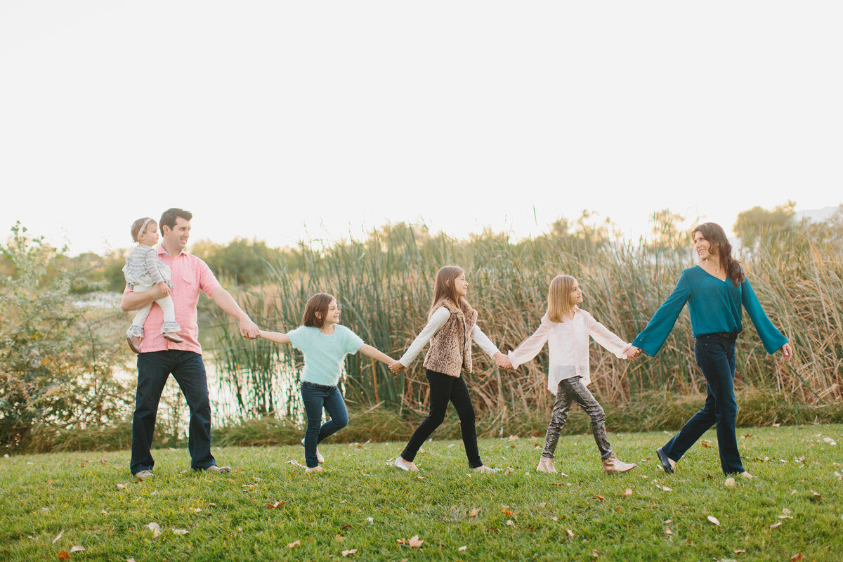 Extended family holding hands walking by the lake, Boise family photos