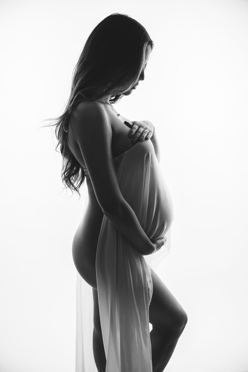 Backlit maternity portrait with sheer draped fabric, Boise maternity photographer fine art session