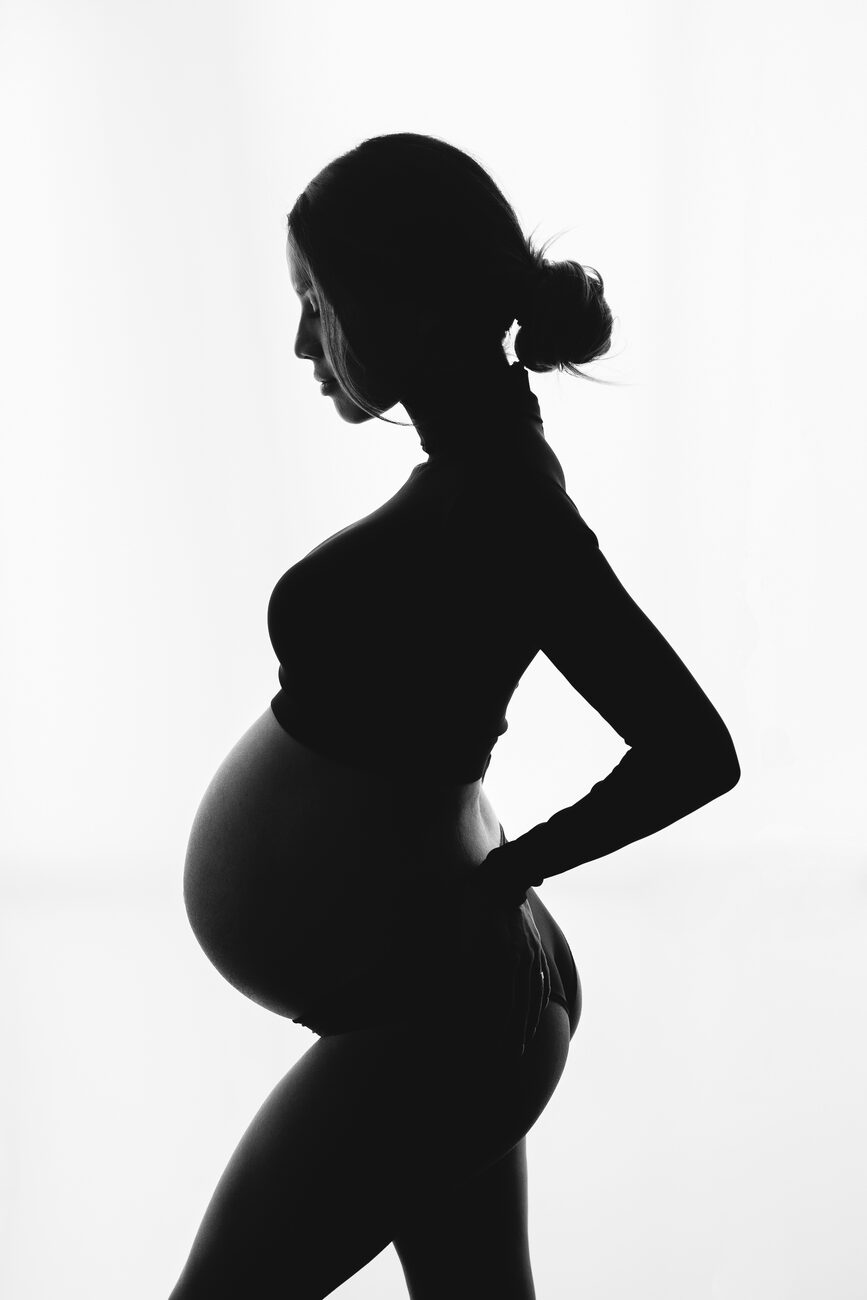 Backlit standing maternity silhouette, dramatic Boise maternity photography portrait