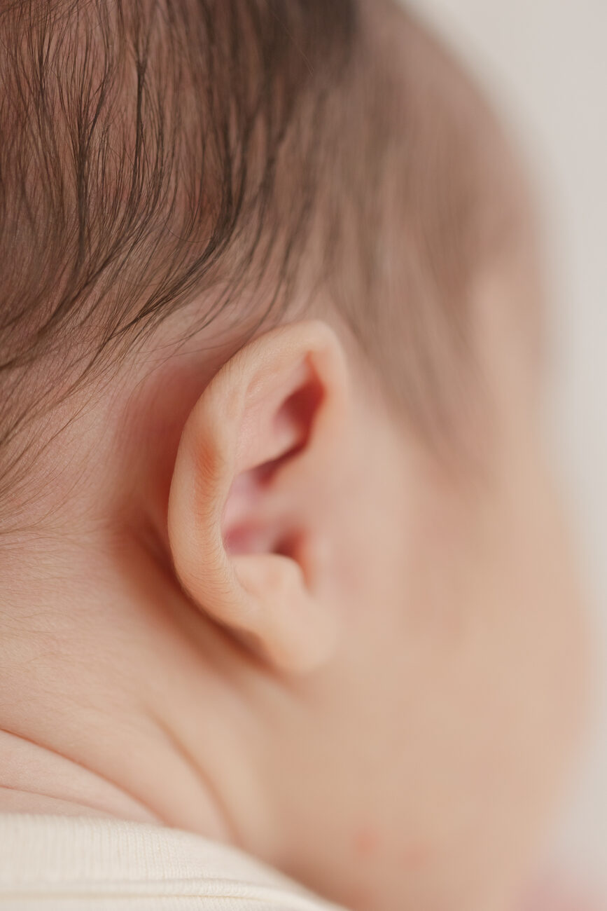 Macro detail of a newborn’s ear and soft hair, Boise newborn photography in neutral tones