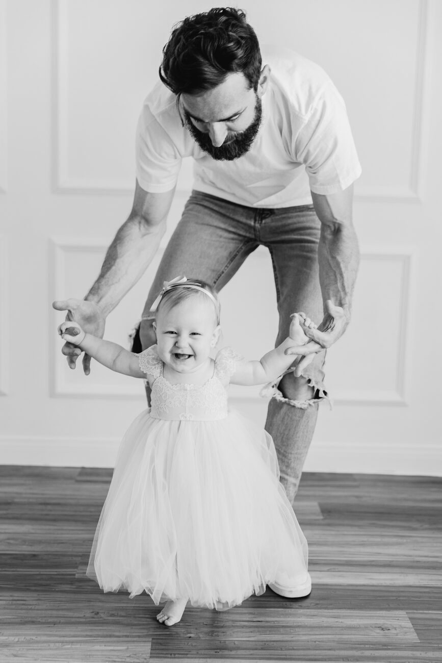 first birthday photography Boise, dad walking one year old in tulle dress