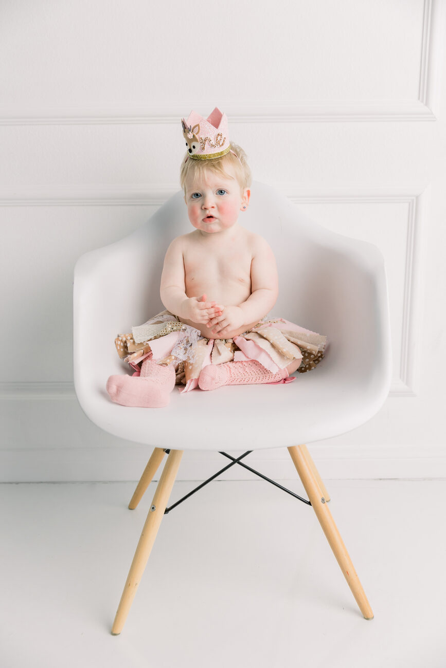 one year photos Boise, birthday girl in crown sitting on white chair